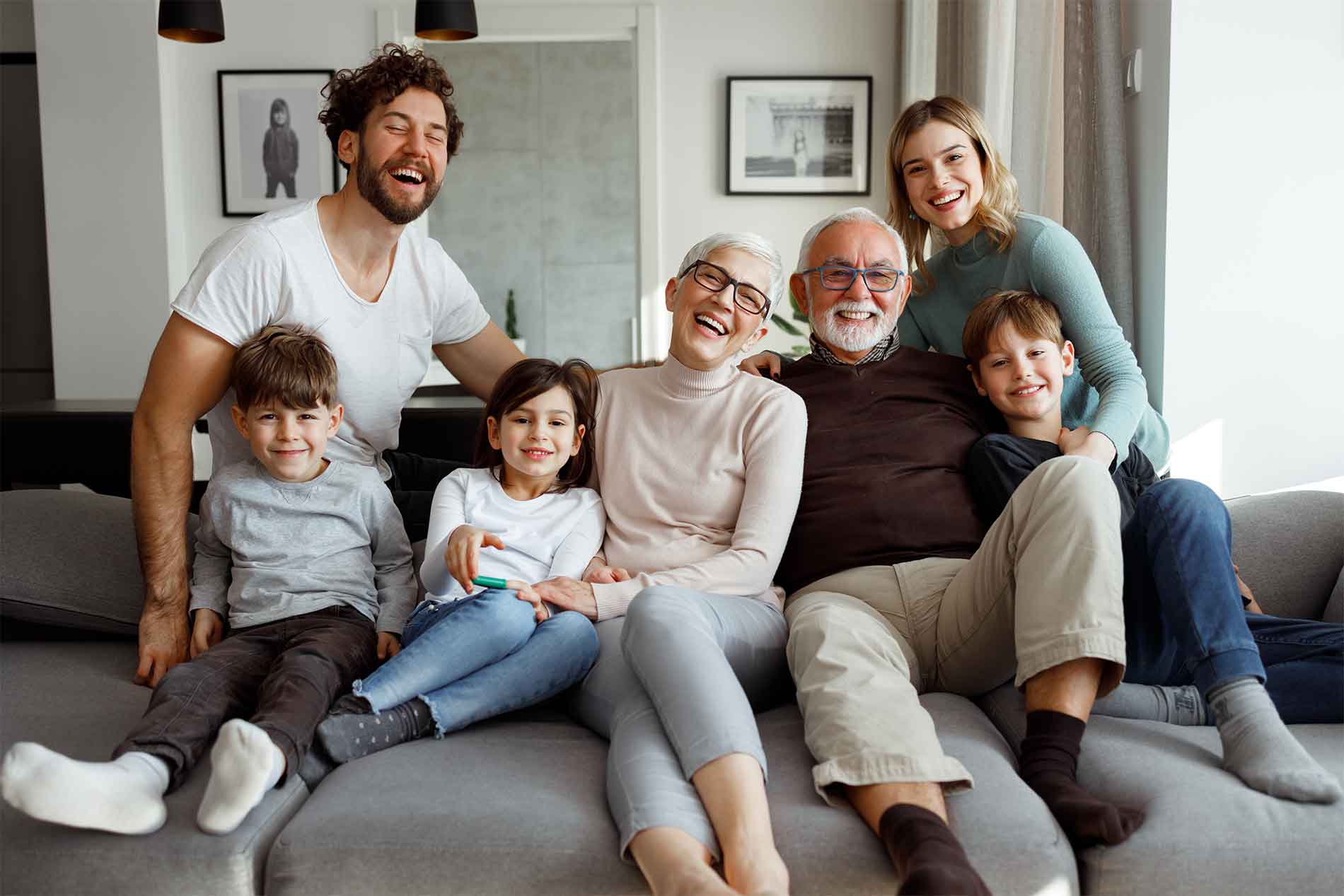 Multi-generational family sitting together on a couch